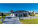 Luxury waterfront home with modern design and a landscaped yard at 5117 Collingswood Blvd, Port Charlotte, FL 33948