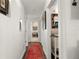 Bright hallway with red runner rug leading to other rooms at 5117 Collingswood Blvd, Port Charlotte, FL 33948