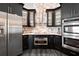 Modern kitchen with stainless steel appliances and dark cabinetry at 5117 Collingswood Blvd, Port Charlotte, FL 33948