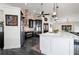 Modern kitchen with white cabinets, large island, and brick backsplash at 5117 Collingswood Blvd, Port Charlotte, FL 33948