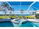 Stunning pool and spa with a covered patio and peaceful water views at 5117 Collingswood Blvd, Port Charlotte, FL 33948