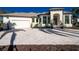 White two-story house with gray roof, paver driveway, and tropical landscaping at 435 La Sila Ct, Punta Gorda, FL 33950