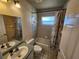 Bathroom featuring a vanity with gray countertop, a toilet, and a shower/tub with a decorative shower curtain at 12070 Surrey Ave, Port Charlotte, FL 33981