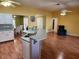 Spacious kitchen features laminate flooring, a ceiling fan, recessed lights, white cabinetry, and a breakfast bar at 12070 Surrey Ave, Port Charlotte, FL 33981