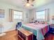 Bedroom with queen bed, wooden accents, and ceiling fan at 14454 Nw Chamberlain Blvd, Port Charlotte, FL 33953