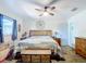 Primary bedroom with king-size bed, wooden furniture, and ceiling fan at 14454 Nw Chamberlain Blvd, Port Charlotte, FL 33953