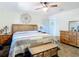 King-size bed, wooden dresser, and ceiling fan in a relaxing bedroom at 14454 Nw Chamberlain Blvd, Port Charlotte, FL 33953