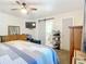 Spacious bedroom with a large bed, dresser, and ceiling fan at 14454 Nw Chamberlain Blvd, Port Charlotte, FL 33953