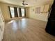 Bright living room with wood-look tile flooring and large windows at 14454 Nw Chamberlain Blvd, Port Charlotte, FL 33953