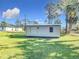 Gray metal storage shed in backyard, providing ample storage space at 14454 Nw Chamberlain Blvd, Port Charlotte, FL 33953