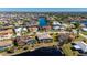 Aerial view of a house with a pool, located on a canal in a residential area at 831 Via Tunis, Punta Gorda, FL 33950