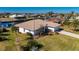 Aerial view of single-story home with canal access and lush landscaping at 831 Via Tunis, Punta Gorda, FL 33950