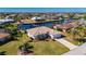 Aerial view of a single-story home on a canal, featuring a spacious backyard at 831 Via Tunis, Punta Gorda, FL 33950