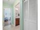 Bright hallway bathroom with a vanity and access to bedroom at 831 Via Tunis, Punta Gorda, FL 33950