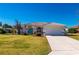 Single-story home with tile roof, white exterior, and landscaped lawn at 831 Via Tunis, Punta Gorda, FL 33950