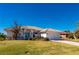 Single-story home with tile roof, white exterior, and landscaped lawn at 831 Via Tunis, Punta Gorda, FL 33950