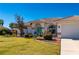 Single-story home with tile roof, white exterior, and landscaped lawn at 831 Via Tunis, Punta Gorda, FL 33950