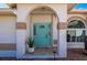 Front entry with teal door, arched entryway, and decorative stone at 831 Via Tunis, Punta Gorda, FL 33950