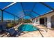 Relaxing screened-in pool area with lounge chairs at 831 Via Tunis, Punta Gorda, FL 33950