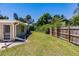 Large grassy backyard with wooden fence at 2112 Mark Ave, Punta Gorda, FL 33950