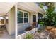 Side view of house with screened porch and landscaping at 2112 Mark Ave, Punta Gorda, FL 33950