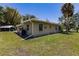 Side view of house showcasing lawn and landscaping at 2112 Mark Ave, Punta Gorda, FL 33950