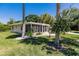 View of house from the side with landscaping at 2112 Mark Ave, Punta Gorda, FL 33950