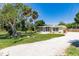 Single-story home with a screened porch and lush landscaping at 2112 Mark Ave, Punta Gorda, FL 33950