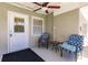 Relaxing front porch with two comfy chairs and a small table at 2112 Mark Ave, Punta Gorda, FL 33950