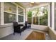 Screened porch with two wicker chairs and a rug at 2112 Mark Ave, Punta Gorda, FL 33950