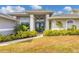 Gray house with blue front door, landscaping, and walkway at 430 Spring Lake Nw Blvd, Port Charlotte, FL 33952