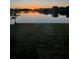 Stunning sunset view over tranquil lakefront property at 430 Spring Lake Nw Blvd, Port Charlotte, FL 33952