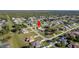 Aerial view of home situated in a quiet neighborhood with well-maintained lawns and mature trees at 98 Seasons Dr, Punta Gorda, FL 33983