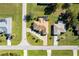 Aerial view of house surrounded by mature trees, and landscaping at 98 Seasons Dr, Punta Gorda, FL 33983