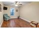 Cozy bedroom with hardwood floors, a ceiling fan, and ample natural light at 98 Seasons Dr, Punta Gorda, FL 33983