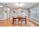 Bright dining room with stylish light fixture and seating for four at 98 Seasons Dr, Punta Gorda, FL 33983