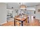 Open-concept dining room leading to the living room with hardwood floors at 98 Seasons Dr, Punta Gorda, FL 33983