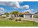 Well-maintained single-story home featuring a two-car garage, beautiful landscaping, and a circular driveway at 98 Seasons Dr, Punta Gorda, FL 33983