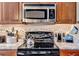 Modern kitchen features black cooktop, stainless microwave, and tiled backsplash at 98 Seasons Dr, Punta Gorda, FL 33983