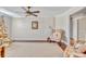 Bright living room featuring hardwood floors, ceiling fan and a large area rug at 98 Seasons Dr, Punta Gorda, FL 33983