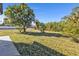 Large backyard with mature trees and grass at 2387 Tamarind St, Port Charlotte, FL 33948