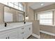 Stylish bathroom, featuring a large mirror and white cabinets at 2387 Tamarind St, Port Charlotte, FL 33948