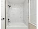 Updated bathroom with white marble tile shower/tub combo at 2387 Tamarind St, Port Charlotte, FL 33948