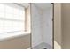 Clean bathroom with marble shower and polka dot floor at 2387 Tamarind St, Port Charlotte, FL 33948