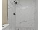 Shower with marble-look tile and polka dots at 2387 Tamarind St, Port Charlotte, FL 33948