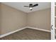 Simple bedroom with wood-look floors and ceiling fan at 2387 Tamarind St, Port Charlotte, FL 33948