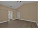 Bright bedroom featuring wood-look floors and an ensuite bathroom at 2387 Tamarind St, Port Charlotte, FL 33948