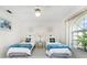 Guest bedroom with twin beds, ceiling fan, and large window at 279 Mariner Ln, Rotonda West, FL 33947