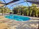 Relaxing kidney-shaped pool with a screened enclosure at 279 Mariner Ln, Rotonda West, FL 33947