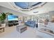 Comfortable living room featuring modern décor, a tray ceiling with fan, and an open layout at 5541 Almar Dr, Punta Gorda, FL 33950